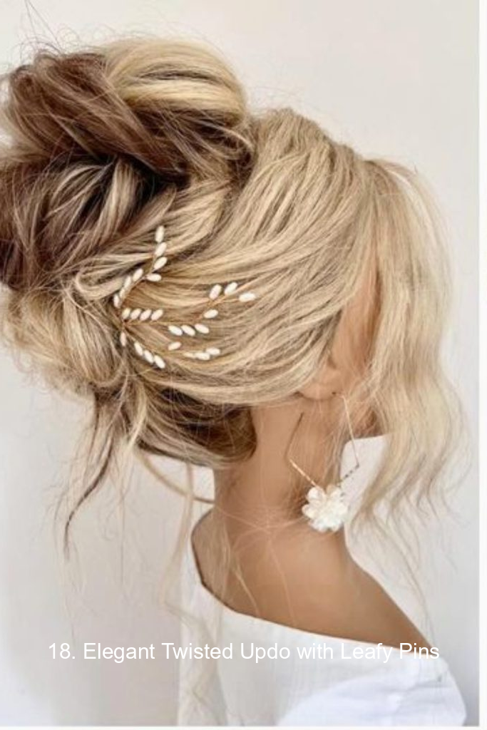 18. Elegant Twisted Updo with Leafy Pins
