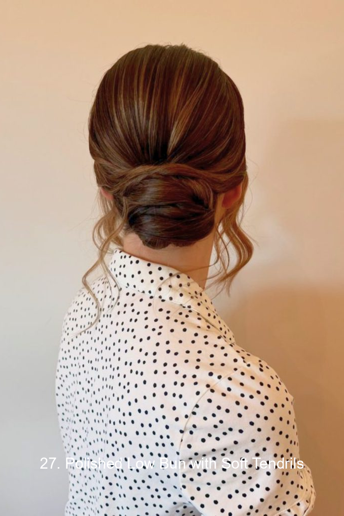 27. Polished Low Bun with Soft Tendrils