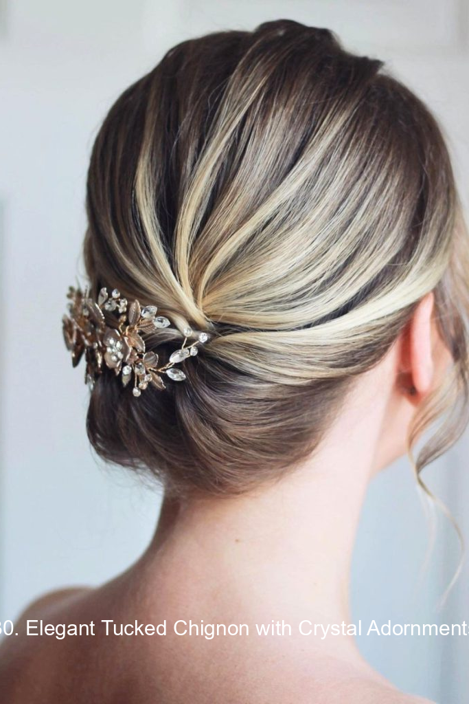 30. Elegant Tucked Chignon with Crystal Adornments