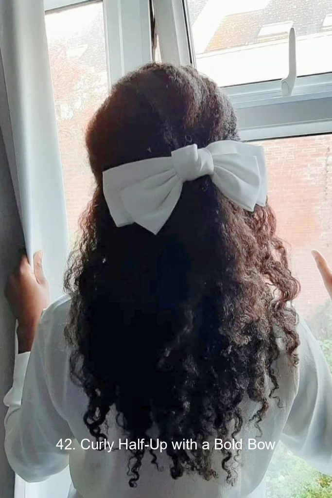 42. Curly Half-Up with a Bold Bow